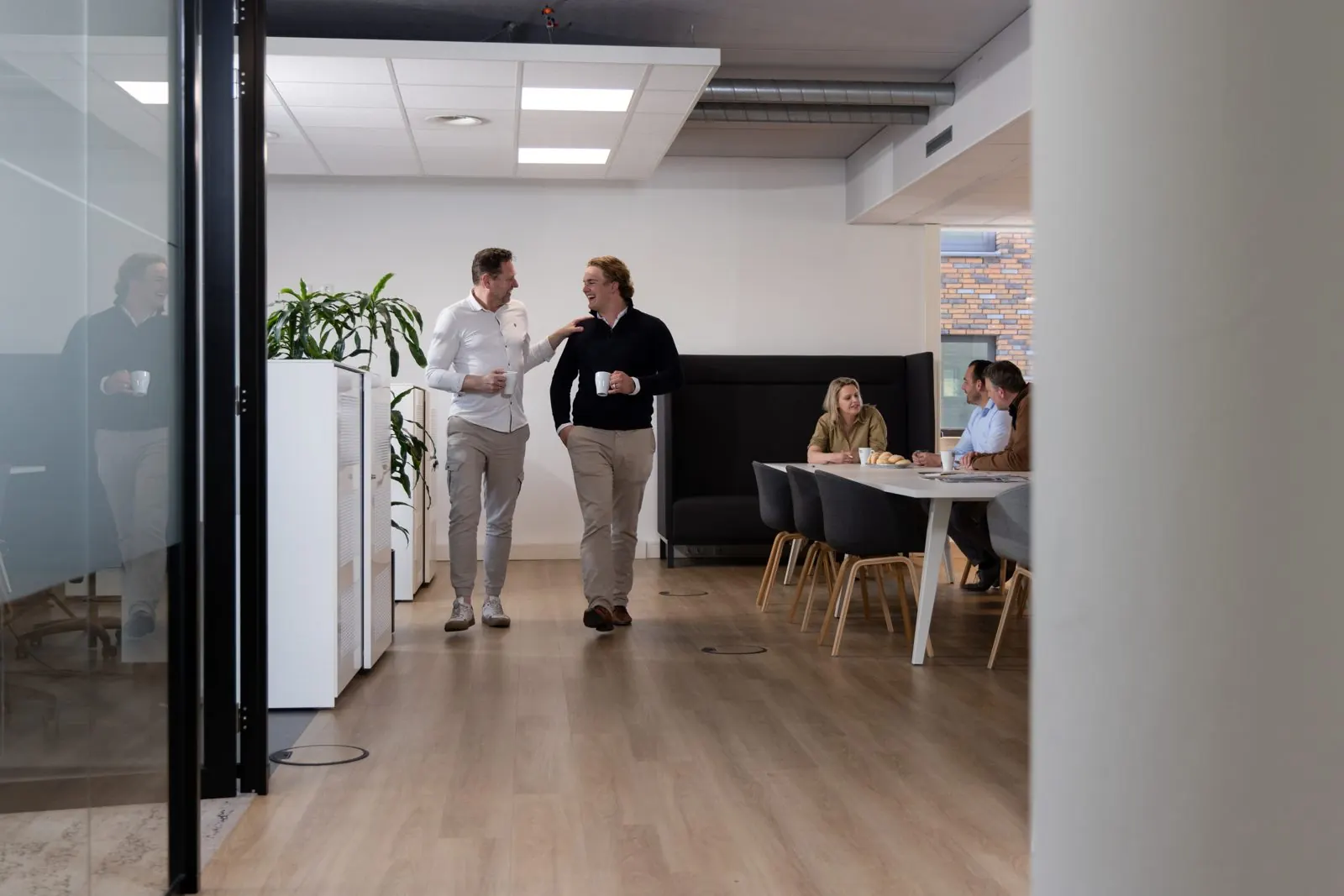 Collega's lopen door het kantoor van bufr